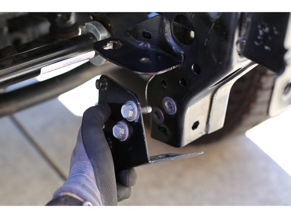 Using a 16mm socket remove the bolt on the inside of each frame rail that holds on the bumper mount support. Place the bumper mount supports close by, they will be re-used.