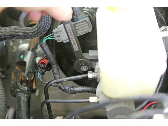 Use a 13mm wrench or socket and loosen the RH nut on the brake master cylinder. You don’t need to remove it, just loosen it until you have a 1/4″ gap between the nut and the flange.