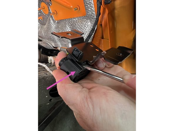 Remove the two nuts holding the wheel sensor plug bracket to the firewall with a 10mm socket or wrench. Save the nuts as they will be used later.