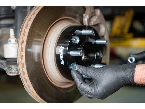 Thread on the provided lug nuts onto the wheel studs.