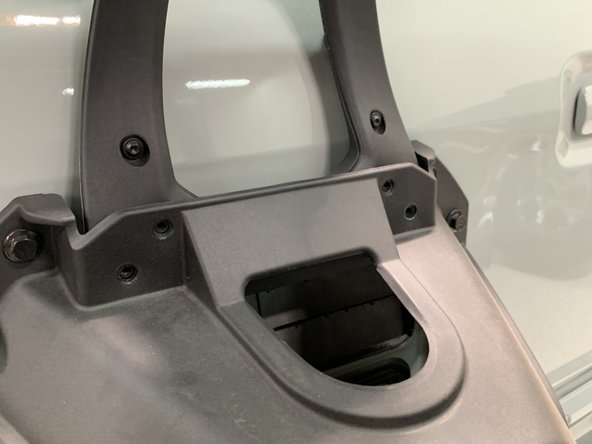 Note that the 3rd brake light bracket's screw holes key into the spare tire mounting bracket.