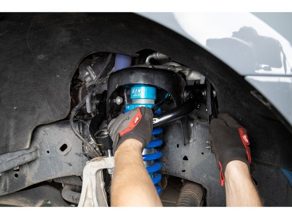 Torque pivot bolt to 111 lb-ft [150 Nm].