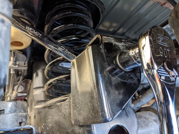 Move onto the rear axle side track bar mount