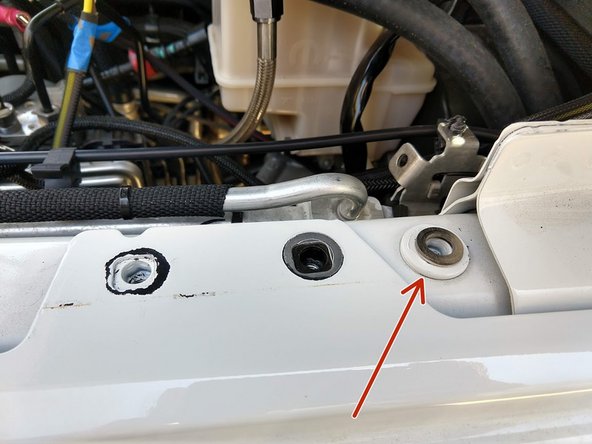 Place the provided 5/16&quot; flat washer over the hole to the right of the fender bolt removed.