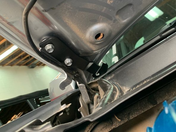 There are a left and right hood hinge light bracket. Make sure you have the correct bracket for the side you are installing. The brackets install from the center of the vehicle out, with the slots sliding over the hood bolts as shown.