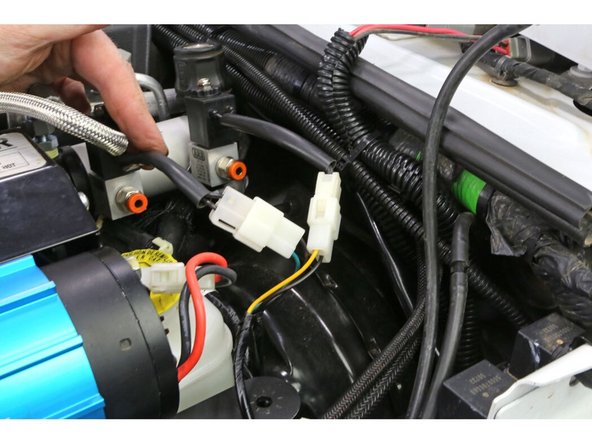 Plug the two white plugs on the switch harness into the manifold solenoids. It is good practice to plug the lead with the green wire into the front solenoid as a reminder that it is the lead for the front air locker and then plug the lead with the yellow wire into the rear solenoid as a reminder that it is the lead for the rear air locker.
