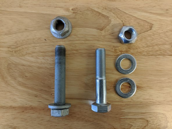 Remove the rear frame side track bar bolt and nut with a 21mm .