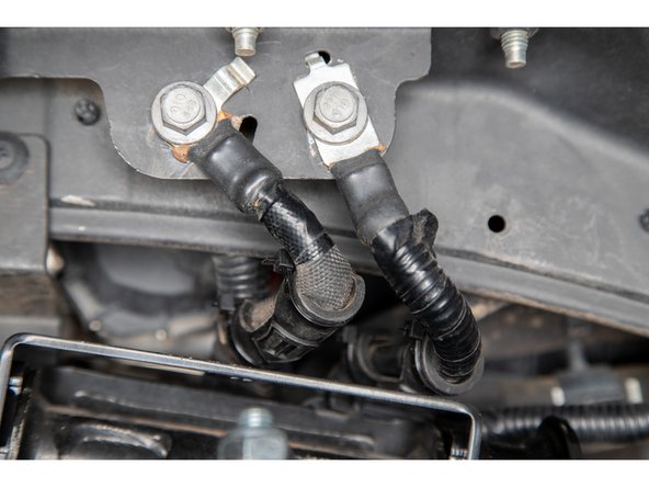 On the driver side, there are ground wires that will contact the UCA bucket bracket. To protect the wires, use the supplied hose protectors and zipties on the wires.