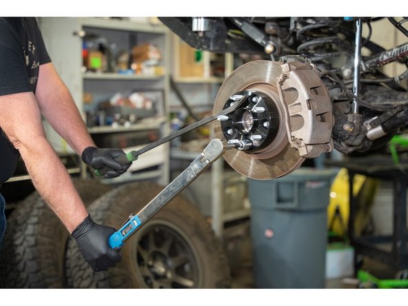 Jeep JK: Torque the lug nuts to 100 lb-ft [135 N-m].