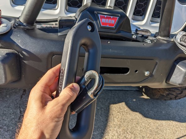 Install one washer and button head screw through the fairlead, and then pass the winch line through the fairlead.