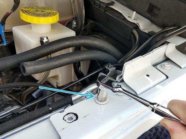 Remove the fender bolt shown with a 10mm wrench/socket.