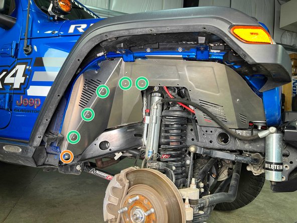 Install the rear lower fender liner section behind the already installed  rear fender liner section with five of the provided M5 screws as shown.