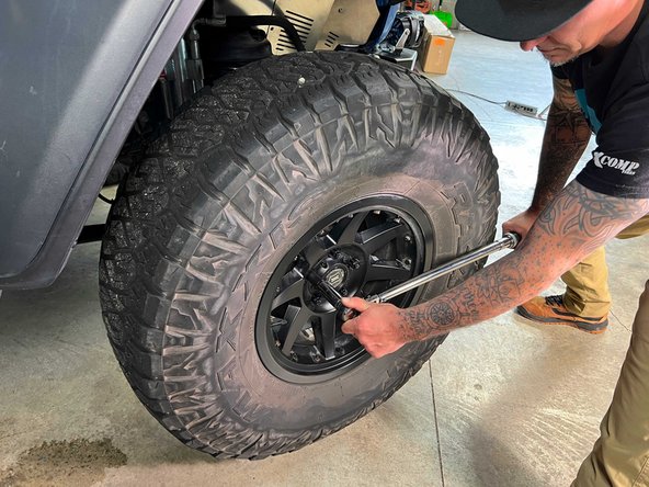 With a 22mm socket and torque wrench, torque the lug nuts in a star pattern to 130 lb-ft [176 N-m].