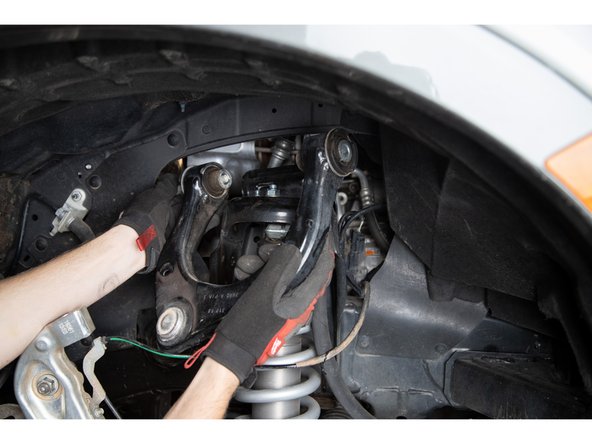 Remove the upper control arm assembly from the vehicle.