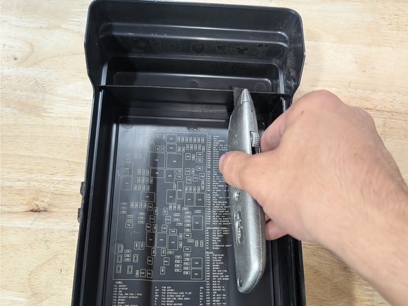 Route the fuse tap out of the fuse box as shown.