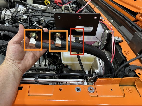 Place the provided 5/16&quot; flat washer over the hole to the right of the fender bolt removed.