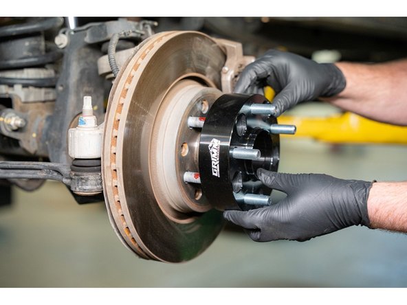 Install the wheel spacer onto the wheel studs.