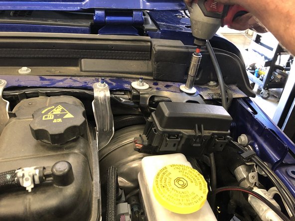 Remove the painted fender bolt and both  bolts securing the fuse/relay box with a 10mm wrench/socket.