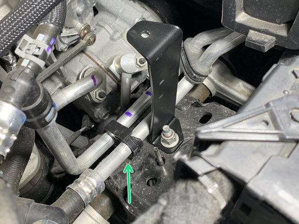 Reinstall the left coolant line clip onto the coolant lines and insert the christmas tree clip end on the bottom back into the hole in the shock tower where it was removed from.