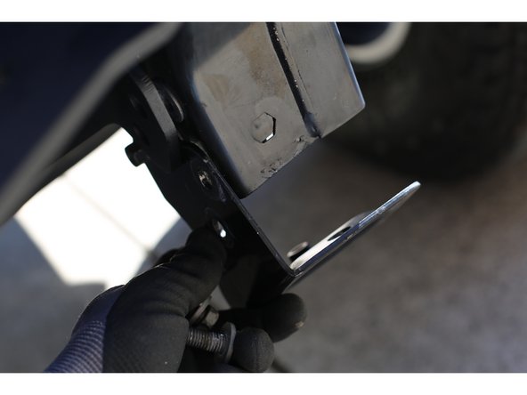 Note the orientation of the sway bar disconnect motor if equipped. The motor hanger/isolator must be oriented hanging down as shown. Some vehicles come with the motor hanger/isolater over-centered towards the vehicle and this needs to be corrected for the winch plate to properly fit.