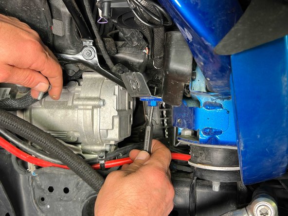 A small punch or alignment tool can be used to help line up the bracket.