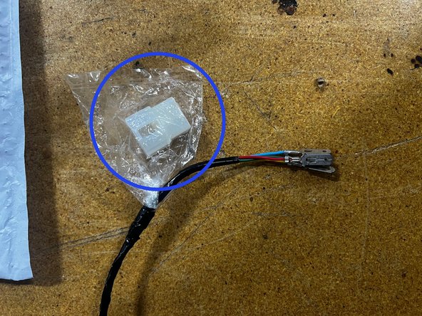 On the ARB power harness coming from the compressor, there should be a white connector housing in a bag attached to some male spade terminals. We are going to use only the red spade terminal from the ARB power harness and connect it to the provided white connector housing as shown.