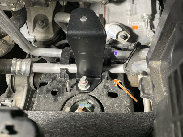 Reinstall clip back onto the coolant lines on the right side of the installed support bracket.