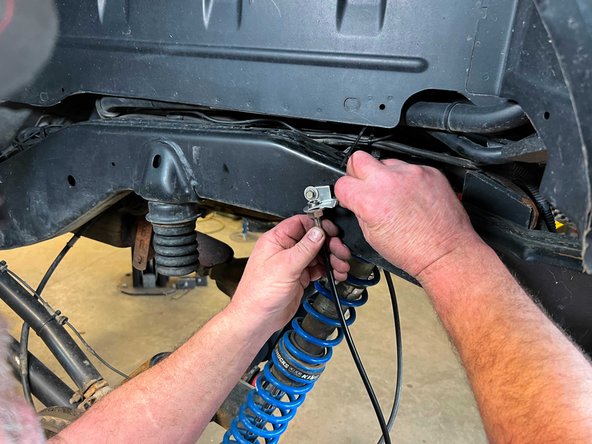 Insert the Grimm OffRoad brake line up through the newly installed brake line bracket on the frame and secure with the provided clip.