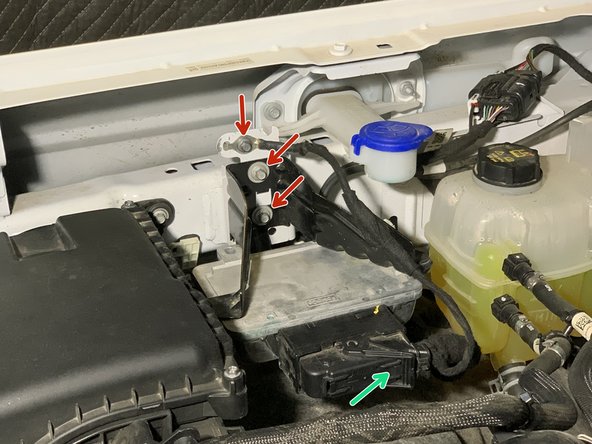 Loosen and remove the 3 bolts holding the ground wire and PCM Mounting Bracket to the vehicle using an 8mm socket/wrench.