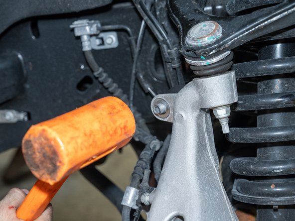 A mallet may be needed to help push the sway bar link stud out of the knuckle.