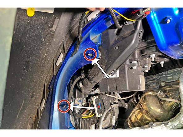 With your trim removal tool, remove the wire harness locating push pins as shown at the rear of the fenderwell.