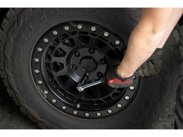 Re-install wheels and put vehicle back on the ground.