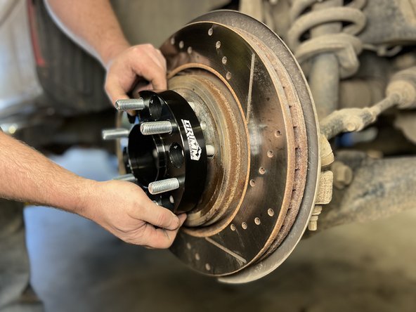 Install the wheel spacer onto the wheel studs.