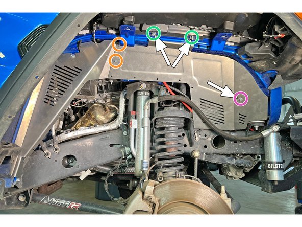 Position the front inner fender liner section back into place and install two of the provided M6 screws, with a washer under each screw head. The screws should go through the fender flare, the fender sheet metal, and then into the clip barrel nuts.