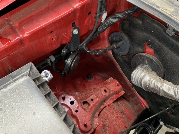 If no ABS Module is present and the vehicle's horn is mounted here, relocate the horn to the rear bolt hole and hang the horn bracket's locating tab off the back of the Fender Bracket.