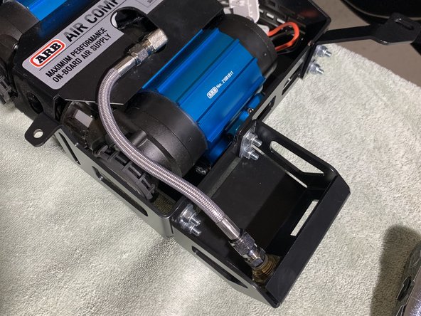 Install one end of the included Stainless Steel Pressure Hose on to the NPT fitting on the compressor.