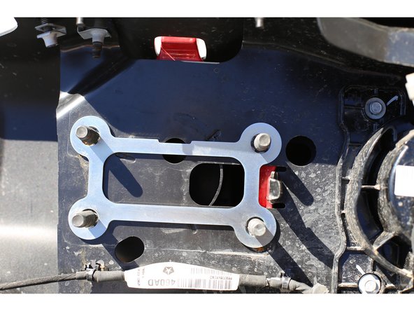 Make sure the fairlead opening on the Grimm Fairlead Plate and the factory bumper line up before tightening.