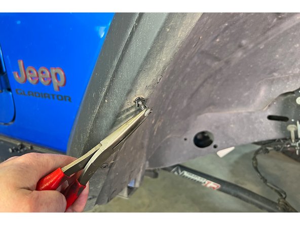 Remove the eight plastic rivets that secure the inner fender to the fender. A small punch can be used to push the center through, then the rivet can be pulled out.