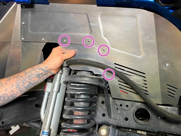 Install the front lower fender liner section behind the already installed  front fender liner section with four of the provided M5 screws as shown.