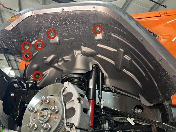 Re-install the five screws using a 10mm socket/wrench and press the push pin back into place.