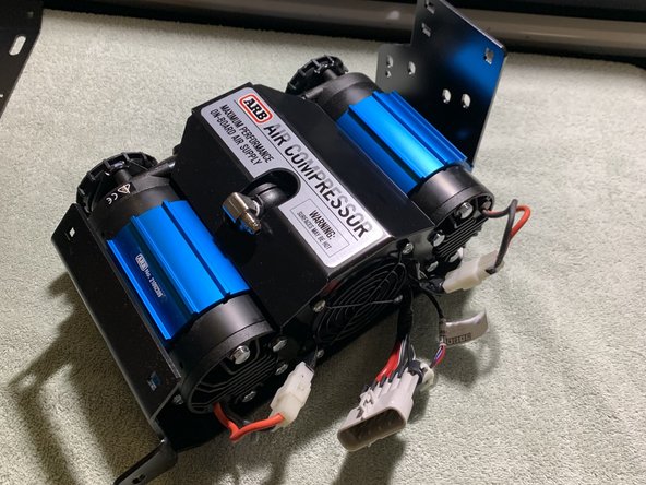 Secure the compressor onto the Grimm Offroad Main Bracket using the ARB supplied 6mm hardware with a 10mm socket/wrench.