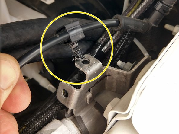 The clip on the fender holding the washer line needs to be flipped upsidedown, to the other side of the bracket as shown.