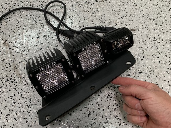 Install the lights you are planning to use to the bracket before installing the bracket to the vehicle.