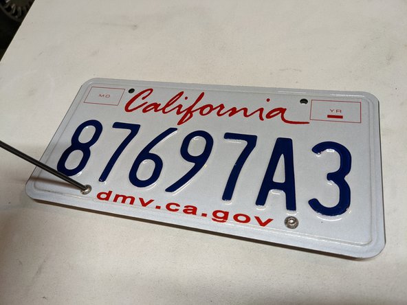 Install your license plate on the plate bracket. The cage nuts go on the bottom, as shown in the photos. Snug hardware but do not fully tighten yet.