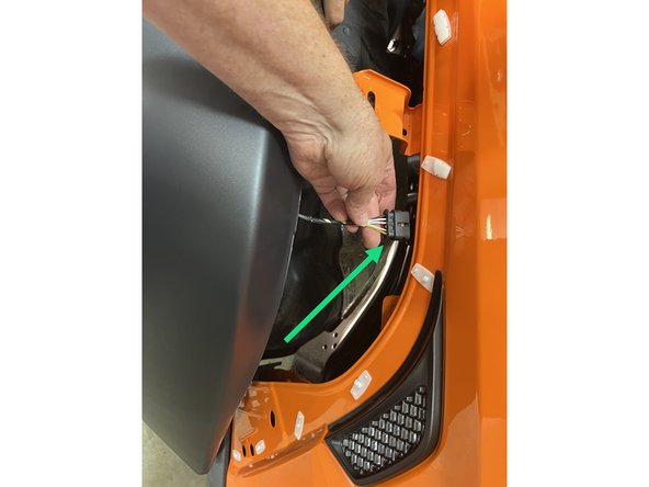 Reconnect the side marker light wire harness connector and push the red locking tab in.