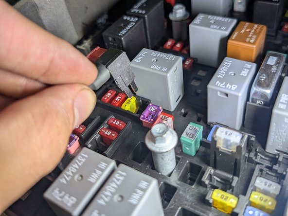Remove the fuse box cover and locate the F58 fuse. Use the fuse puller to remove the yellow 20A fuse from this location.