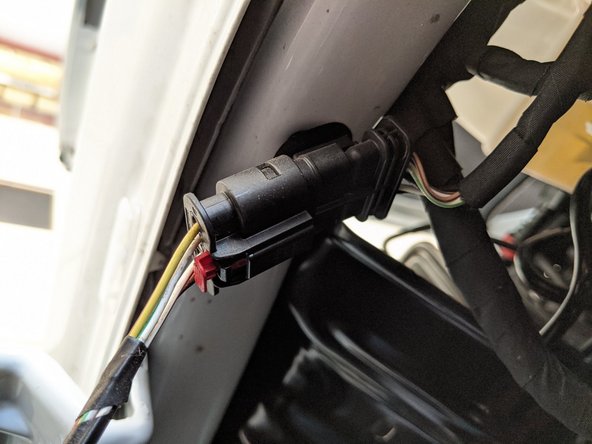 Reconnect the side marker light wire harness connector and push the red locking tab in.