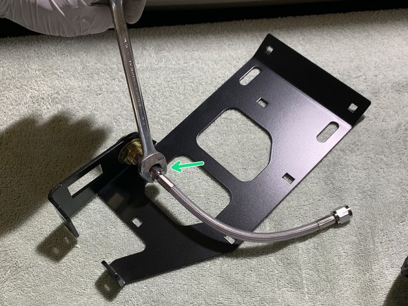 Install one end of the included Stainless Steel Pressure Hose on to the previously installed NPT fitting on the PCM Mounting Bracket Assembly using a 9/16&quot; open end wrench.