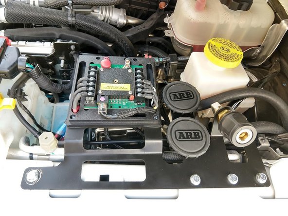 (CKBLTA12 compressor only) - Run the red wire we installed the spade terminal to on the ARB power harness up through the gasket and connect to switch number of choice on the sPOD module. Red wire to SW.