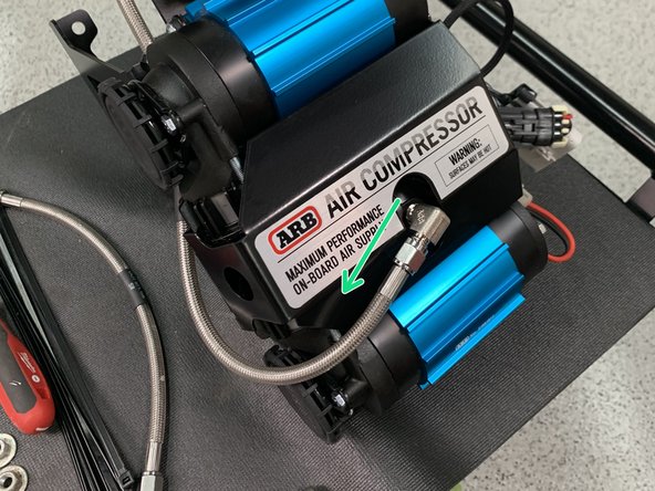 Install the 1/4” NPT x JIC4 90° fitting into the ARB compressor manifold cap using a 9/16&quot; open end wrench. Make sure to use thread sealant on the NPT thread and orient the fitting as shown.